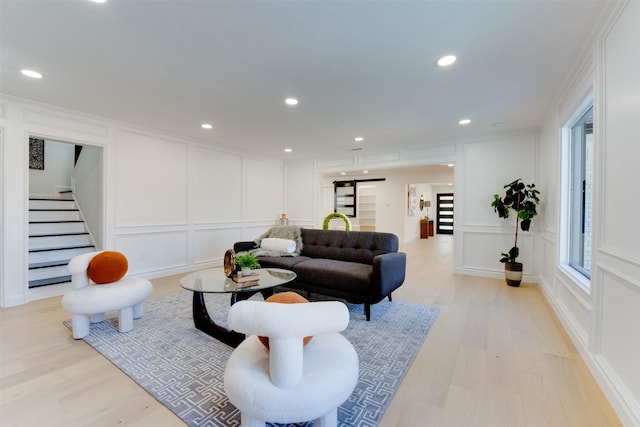 2514 Haverhill Dr, Houston, TX 77008 - living area with a decorative wall, light wood-style floors, stairway, recessed lighting, and crown molding