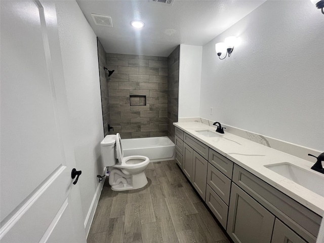 21268 White Oak Dr, Conroe, TX 77306 - bathroom featuring toilet, wood finished floors, double vanity, and tub / shower combination