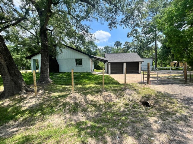 21268 White Oak Dr, Conroe, TX 77306 - back of house featuring brick siding, fence, and driveway