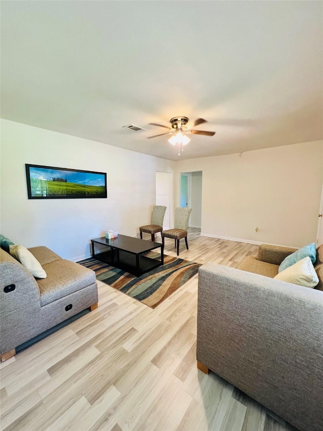 4919 Donald St, Seabrook, TX 77586 - living area with light wood-type flooring, a ceiling fan, and baseboards