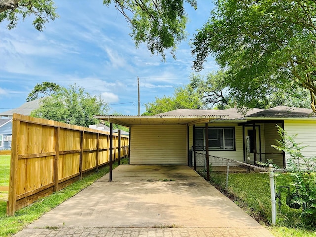 4919 Donald St, Seabrook, TX 77586 - view of front facade with driveway, a carport, and metal roof