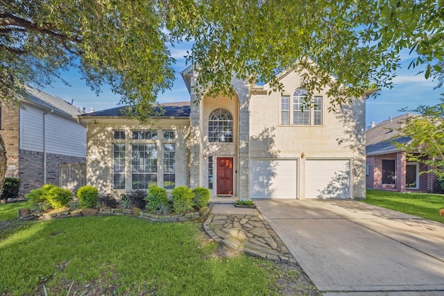 5206 Spring Oak Dr, Pasadena, TX 77505 - traditional-style home with concrete driveway, a front lawn, a garage, and brick siding