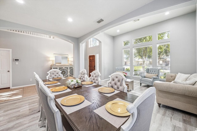 5206 Spring Oak Dr, Pasadena, TX 77505 - dining room with healthy amount of natural light, recessed lighting, arched walkways, and light wood-style flooring