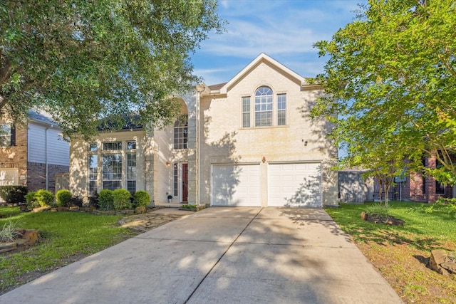 5206 Spring Oak Dr, Pasadena, TX 77505 - traditional-style home with driveway, brick siding, a garage, and a front yard