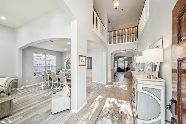 5206 Spring Oak Dr, Pasadena, TX 77505 - foyer featuring plenty of natural light, arched walkways, a towering ceiling, baseboards, and recessed lighting