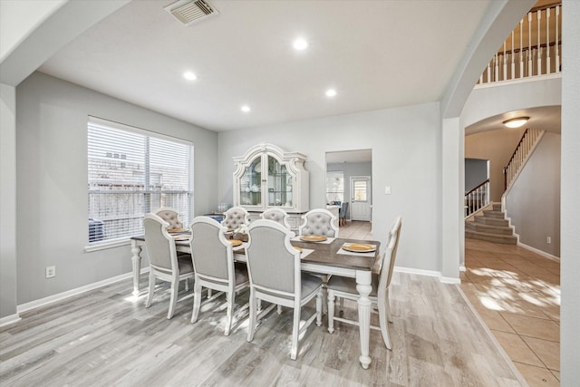 5206 Spring Oak Dr, Pasadena, TX 77505 - dining space featuring plenty of natural light, wood finished floors, stairway, baseboards, and recessed lighting