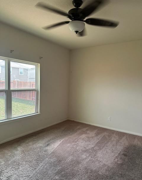 11822 Claudette St, San Antonio, TX 78252 - spare room with carpet floors, ceiling fan, and baseboards