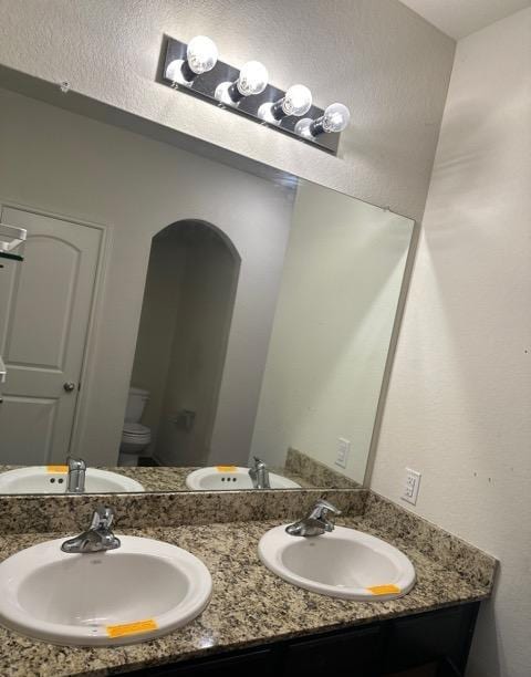 11822 Claudette St, San Antonio, TX 78252 - bathroom with toilet and double vanity