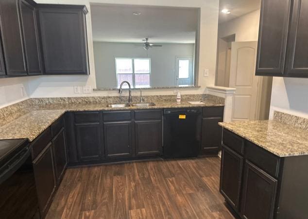 11822 Claudette St, San Antonio, TX 78252 - kitchen with black dishwasher, a sink, dark wood-style flooring, a ceiling fan, and light stone countertops