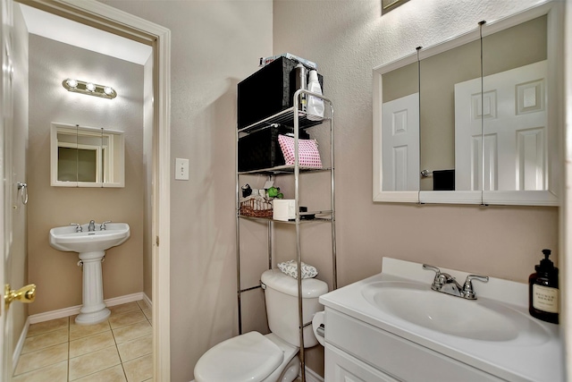 34606 Lake Side Dr, Brookshire, TX 77423 - half bathroom featuring a sink, tile patterned floors, toilet, and baseboards