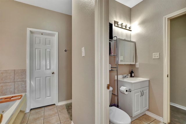 34606 Lake Side Dr, Brookshire, TX 77423 - full bathroom with tile patterned flooring, a bath, vanity, toilet, and baseboards