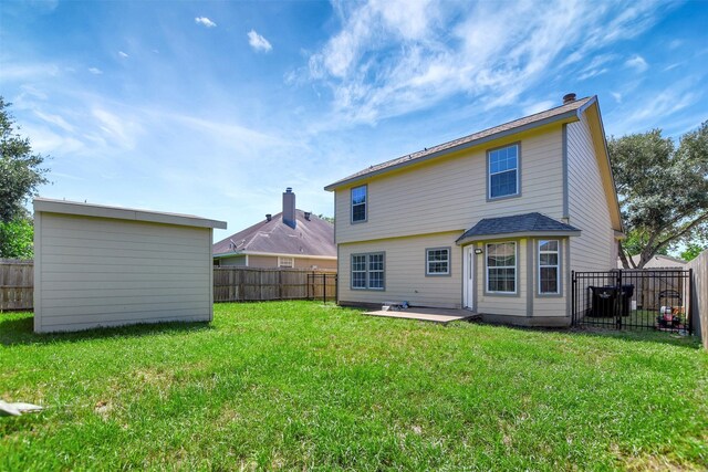 34606 Lake Side Dr, Brookshire, TX 77423 - back of house with an outbuilding, a chimney, a patio area, and a shed