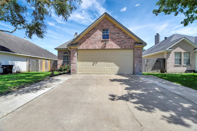 34606 Lake Side Dr, Brookshire, TX 77423 - view of front of house with brick siding, a garage, and concrete driveway