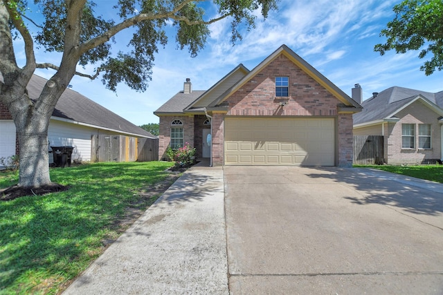 34606 Lake Side Dr, Brookshire, TX 77423 - traditional home featuring brick siding, a chimney, concrete driveway, and a garage