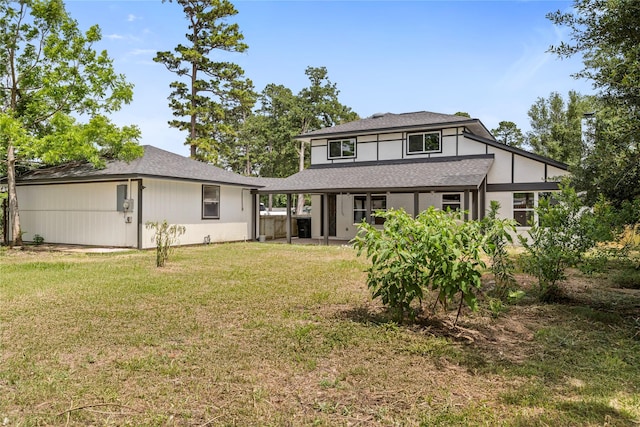 rear view of house with a yard