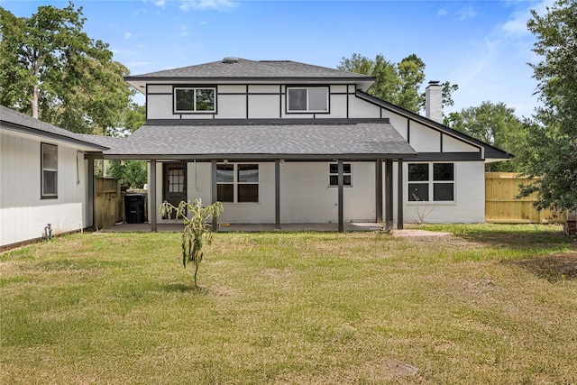 back of property featuring a shingled roof and a chimney