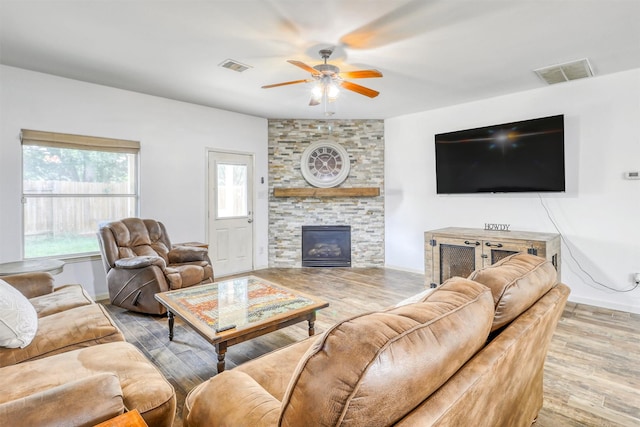 2726 Indigo Stone Ln, Katy, TX 77449 - living room with a ceiling fan, wood finished floors, a fireplace, and baseboards