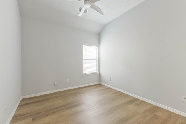 2212 Highland Crossing Dr, Conroe, TX 77304 - empty room featuring a ceiling fan, baseboards, light wood-style flooring, and vaulted ceiling
