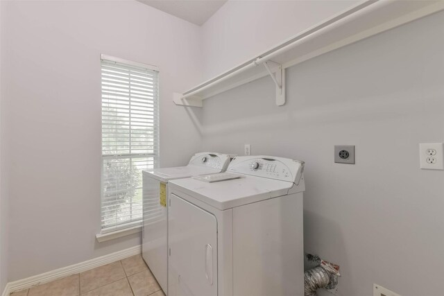 2212 Highland Crossing Dr, Conroe, TX 77304 - washroom with plenty of natural light, baseboards, separate washer and dryer, and light tile patterned flooring