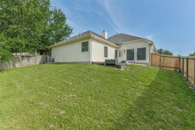 2212 Highland Crossing Dr, Conroe, TX 77304 - back of property featuring cooling unit and a chimney