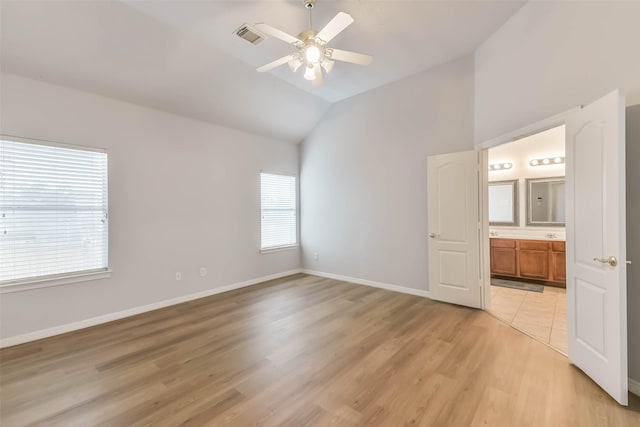 2212 Highland Crossing Dr, Conroe, TX 77304 - unfurnished bedroom with lofted ceiling, light wood finished floors, baseboards, ensuite bath, and ceiling fan