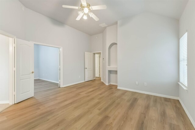 2212 Highland Crossing Dr, Conroe, TX 77304 - unfurnished bedroom featuring light wood-style floors, baseboards, a ceiling fan, and high vaulted ceiling
