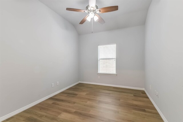 2212 Highland Crossing Dr, Conroe, TX 77304 - spare room with lofted ceiling, ceiling fan, wood finished floors, and baseboards