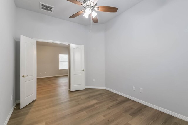 2212 Highland Crossing Dr, Conroe, TX 77304 - unfurnished room featuring light wood-style flooring, a ceiling fan, and baseboards