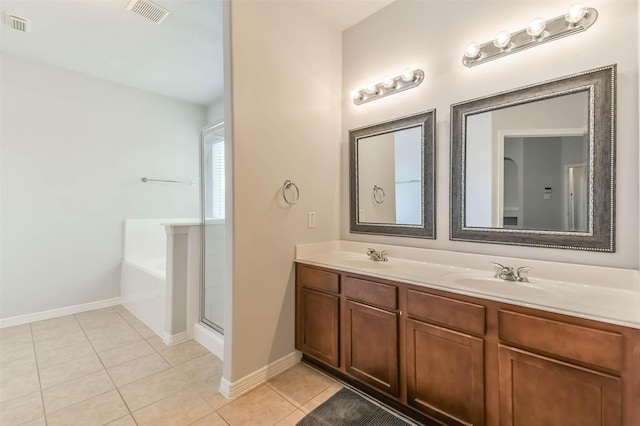 2212 Highland Crossing Dr, Conroe, TX 77304 - bathroom with double vanity, tile patterned floors, baseboards, an enclosed shower, and a tub to relax in