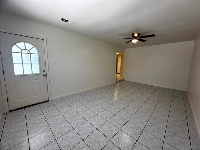 1023 W Snyder St, Alvin, TX 77511 - foyer featuring a ceiling fan, light tile patterned floors, and baseboards