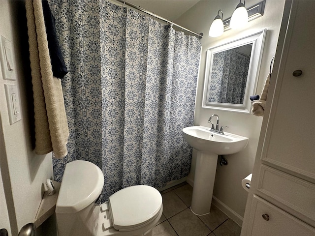 1023 W Snyder St, Alvin, TX 77511 - bathroom with toilet, tile patterned flooring, baseboards, curtained shower, and a sink