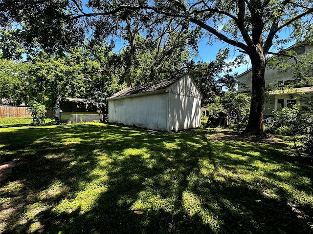 1023 W Snyder St, Alvin, TX 77511 - view of yard with a storage unit and an outbuilding
