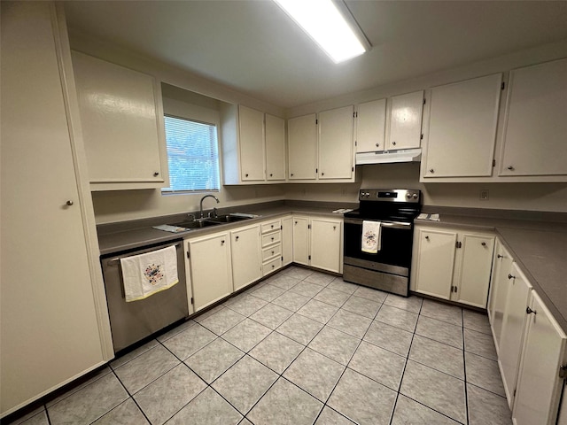 1023 W Snyder St, Alvin, TX 77511 - kitchen with stainless steel appliances, a sink, under cabinet range hood, light tile patterned floors, and white cabinetry
