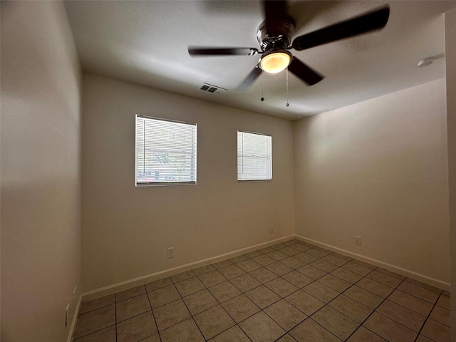 1023 W Snyder St, Alvin, TX 77511 - unfurnished room with light tile patterned floors, ceiling fan, and baseboards