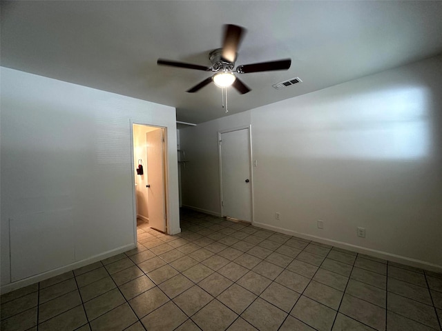 1023 W Snyder St, Alvin, TX 77511 - unfurnished room with a ceiling fan, light tile patterned floors, and baseboards