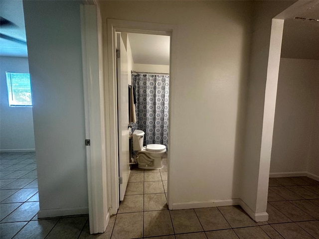 1023 W Snyder St, Alvin, TX 77511 - bathroom with tile patterned flooring, toilet, and baseboards