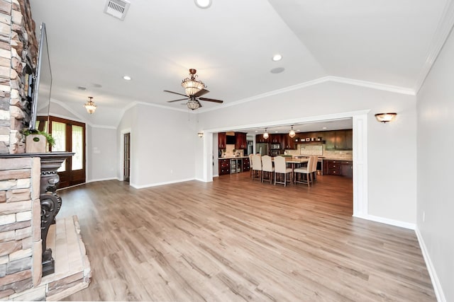 9731 Hadden Rd, Baytown, TX 77521 - unfurnished living room with vaulted ceiling, a ceiling fan, light wood-style flooring, baseboards, and ornamental molding