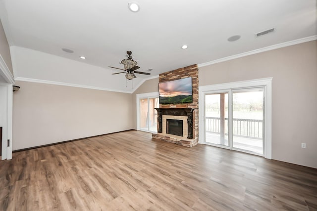 9731 Hadden Rd, Baytown, TX 77521 - unfurnished living room featuring a stone fireplace, ceiling fan, lofted ceiling, ornamental molding, and wood finished floors