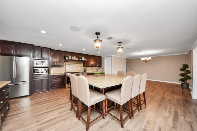 9731 Hadden Rd, Baytown, TX 77521 - dining area featuring light wood finished floors, baseboards, crown molding, a chandelier, and recessed lighting