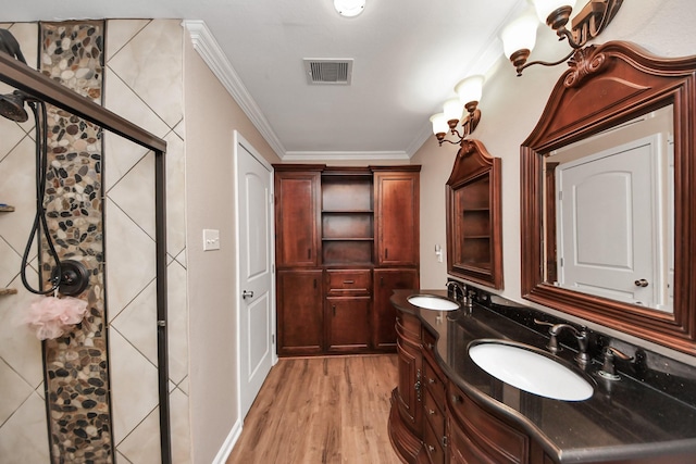 9731 Hadden Rd, Baytown, TX 77521 - bathroom with a shower stall, wood finished floors, crown molding, and double vanity