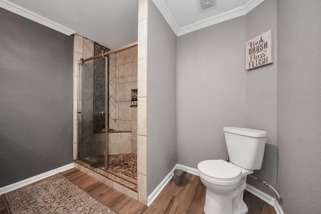 9731 Hadden Rd, Baytown, TX 77521 - full bathroom with ornamental molding, wood finished floors, baseboards, a stall shower, and toilet