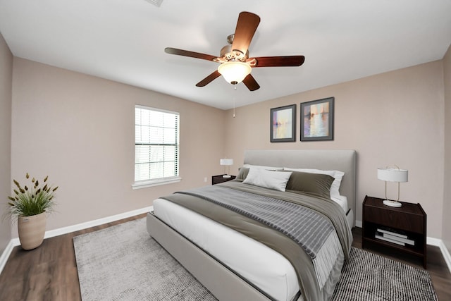 9731 Hadden Rd, Baytown, TX 77521 - bedroom featuring wood finished floors, baseboards, and a ceiling fan