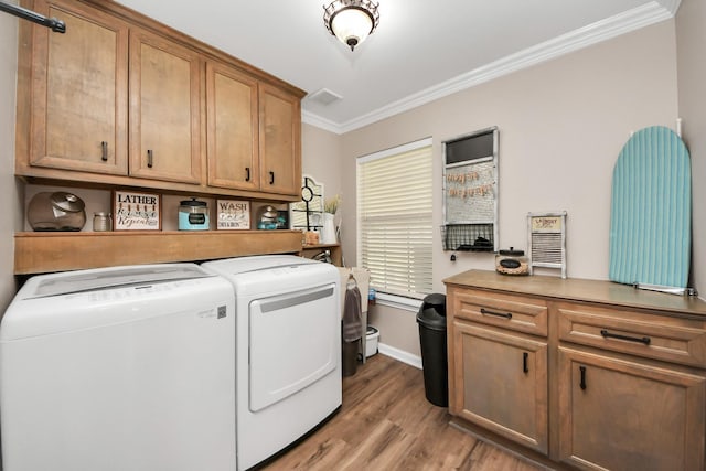 9731 Hadden Rd, Baytown, TX 77521 - washroom with washing machine and dryer, ornamental molding, cabinet space, light wood finished floors, and baseboards