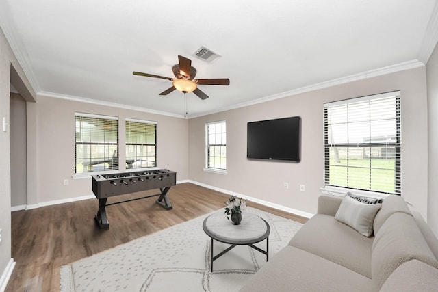 9731 Hadden Rd, Baytown, TX 77521 - living area with wood finished floors, crown molding, ceiling fan, and baseboards