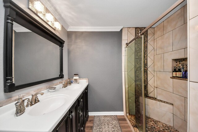 9731 Hadden Rd, Baytown, TX 77521 - full bath with ornamental molding, a shower stall, wood finished floors, double vanity, and baseboards