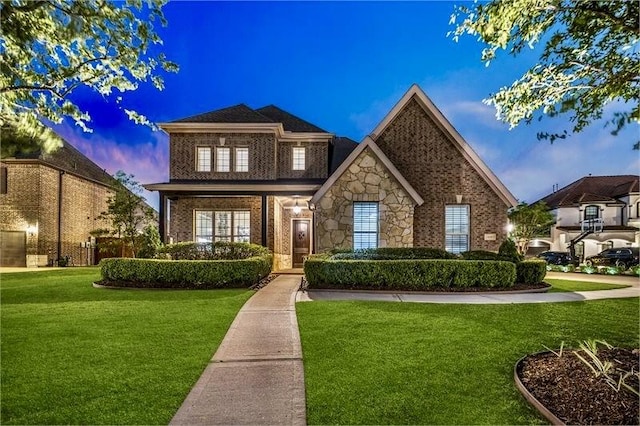 10210 Grape Creek Grove Ln, Cypress, TX 77433 - traditional-style home with a front lawn, brick siding, and stone siding