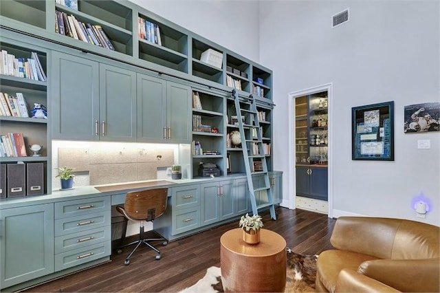 10210 Grape Creek Grove Ln, Cypress, TX 77433 - office area featuring built in desk, dark wood-style floors, a high ceiling, and baseboards