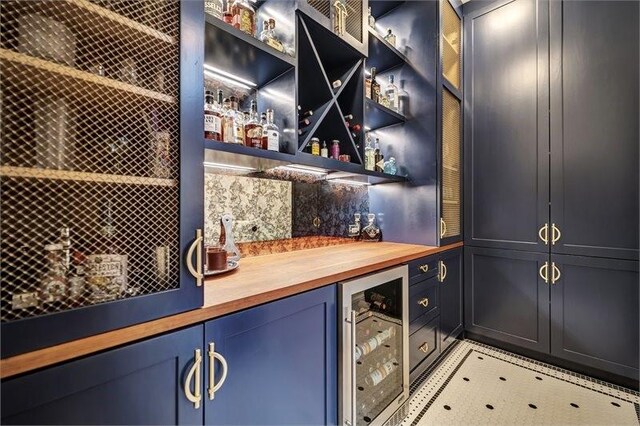 10210 Grape Creek Grove Ln, Cypress, TX 77433 - wine room with beverage cooler and a bar