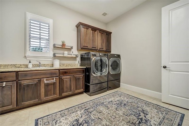 10210 Grape Creek Grove Ln, Cypress, TX 77433 - washroom with cabinet space, independent washer and dryer, light tile patterned flooring, and baseboards