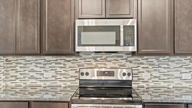 160 Colbys Way, Montgomery, TX 77356 - kitchen with appliances with stainless steel finishes, decorative backsplash, and dark brown cabinetry